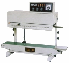 Industrial 2200V sealer machine with digital control panel, used for sealing packages in a production line.