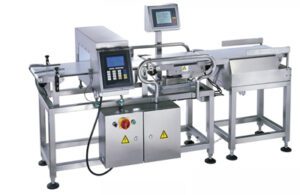 Industrial food packaging machine (MC-1) with control panel and conveyor belts on a steel frame.
