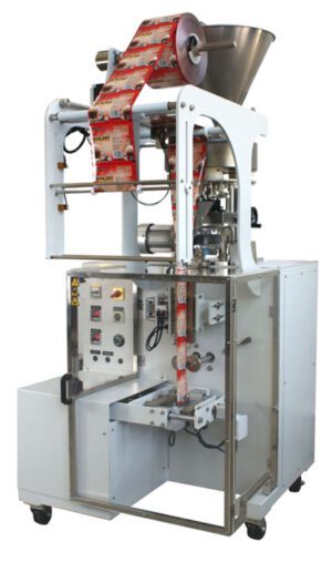 Industrial packaging machine with a roll of 3S85 material, control panel, and metal structure, isolated on a white background.